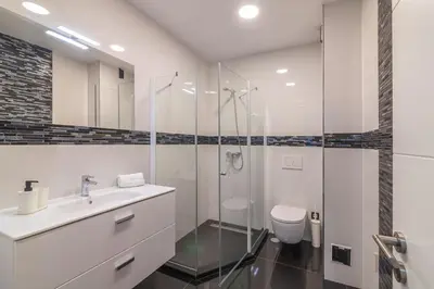 a bathroom with a shower and a toilet and a sink at Vilamoura Premium Apartment With Pool by Homing in Vilamoura