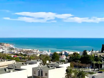 a kitchen with white cabinets and a refrigerator at Apartment Vista Mar Piscina Albufeira in Albufeira