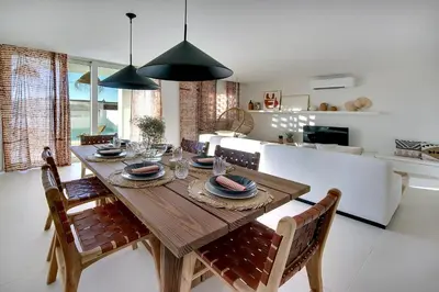 a dining room with a wooden table and chairs at Casa do Pátio-Two Private Pools Villa- Rooftop & Panoramic Pool by DreamvillasAlbufeira in Albufeira
