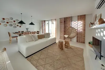 a living room with a white couch and a dining room at Casa do Pátio-Two Private Pools Villa- Rooftop & Panoramic Pool by DreamvillasAlbufeira in Albufeira