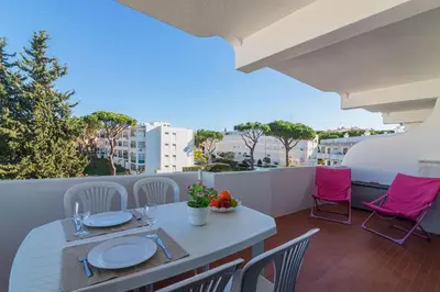 a balcony with a table and chairs on a balcony at Vilamoura Cosy 2 with Pool by Homing in Vilamoura
