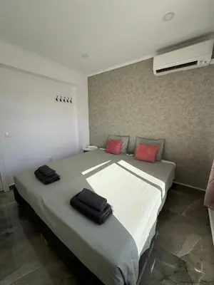 a bedroom with a large bed with red pillows on it at The Strip Oura apartment in Albufeira