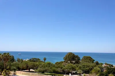 a view of the ocean with a sail boat in the distance at Albufeira - Apartment - Sleeps 4 - Pool - Seaside in Albufeira