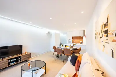 a living room with a couch and a dining room at Apartment Melbourne 2 by Algarve Vacation in Albufeira