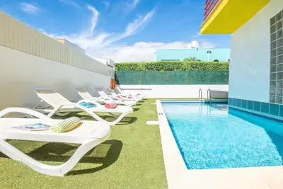 a group of chairs and a swimming pool on a building at Villa Poseidon by Algarve Vacation in Albufeira