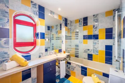 a colorful bathroom with a sink and a mirror at Villa Poseidon by Algarve Vacation in Albufeira