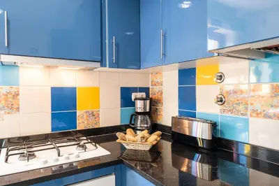 a kitchen with blue cabinets and a counter top at Villa Poseidon by Algarve Vacation in Albufeira