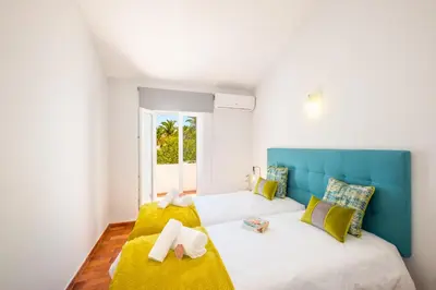 a bedroom with a bed and a couch at Villa Paradisius by Algarve Vacation in Albufeira