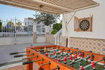 a table with a dart board on a patio at #072 Casa Longa by Home Holidays in Albufeira