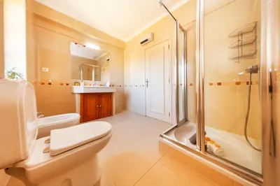 a bathroom with a toilet and a shower at Villa Dalia by Algarve Vacation in Almancil