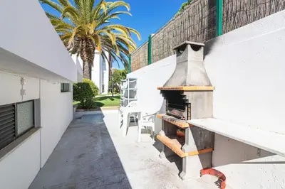 a outdoor pizza oven on the side of a building at Vilamoura - M M GARDEN - Magnifico T2 in Vilamoura
