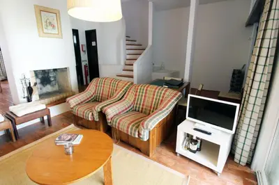 a living room with a couch and a tv at Charming Villa by SAPvillas in Vilamoura