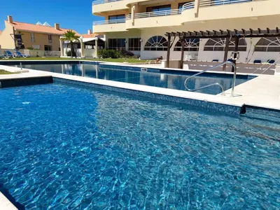 a large swimming pool in front of a building at Marina Mar Light by SAPvillas in Vilamoura