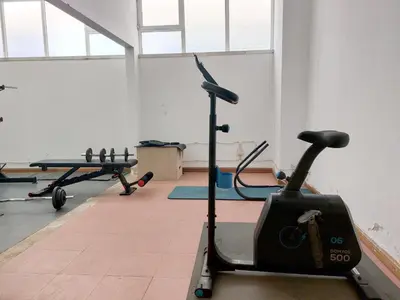 a gym with two exercise bikes and a treadmill at Marina Mar Light by SAPvillas in Vilamoura