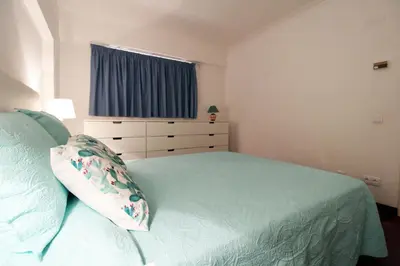 a bedroom with a bed with a pillow and a window at Marina Mar Light by SAPvillas in Vilamoura