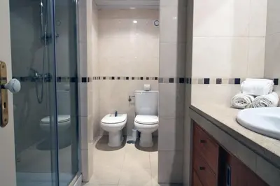 a bathroom with a toilet and a shower and a sink at Marina Mar Sea Breeze by SAPvillas in Vilamoura