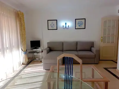 a living room with a couch and a glass table at Marina Mar Sea Breeze by SAPvillas in Vilamoura