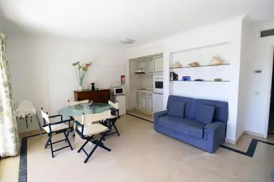a living room with a blue couch and a table at Marina Mar Navigator by SAPvillas in Vilamoura