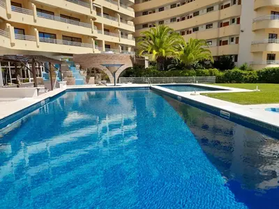 a swimming pool in front of a building at Marina Mar Sailor by SAPvillas in Vilamoura