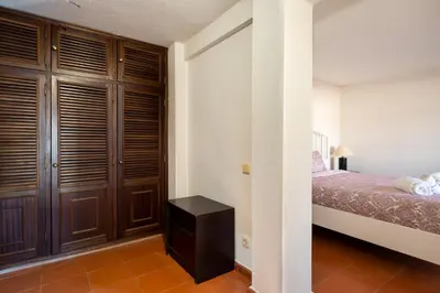 a bedroom with a bed and a closet at Villa Mianas by SAPvillas in Vilamoura