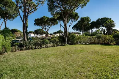 a field of grass with trees in the background at Villa Mianas by SAPvillas in Vilamoura