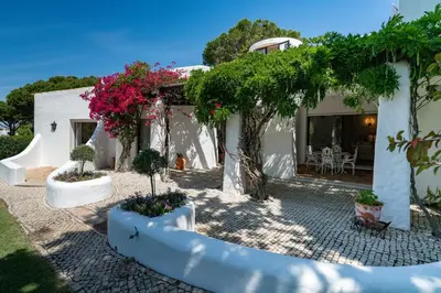 a house with trees and flowers in front of it at Villa Serendipity by SAPvillas in Vilamoura