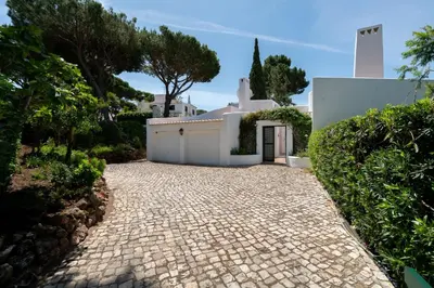 a stone driveway leading to a white building at Villa Serendipity by SAPvillas in Vilamoura