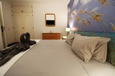 a bedroom with a large bed with a painting on the wall at Marina Mar Marina by SAPvillas in Vilamoura
