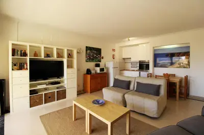 a living room with a couch and a tv at Marina Mar Marina by SAPvillas in Vilamoura