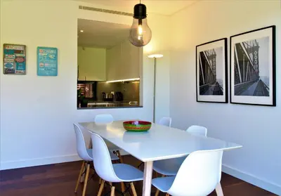 a dining room with a white table and chairs at L'Orangerie Green Garden by SAPvillas in Vilamoura