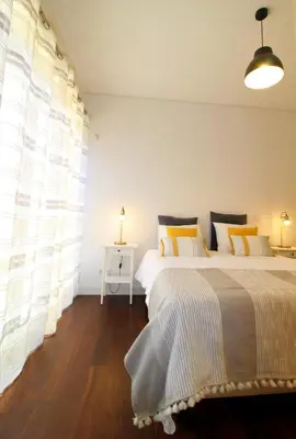 a bedroom with two beds and a window at L'Orangerie Green Garden by SAPvillas in Vilamoura