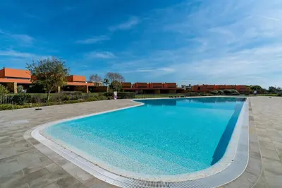 a large swimming pool in front of a building at L'Orangerie Green Garden by SAPvillas in Vilamoura