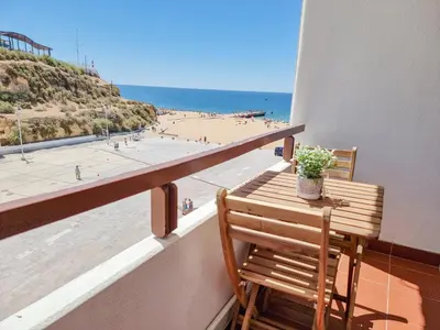 a room with a balcony with a view of the ocean at #070 T0 Edifício Albufeira by Home Holidays in Albufeira