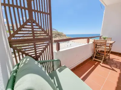 a white apartment building next to a beach at #070 T0 Edifício Albufeira by Home Holidays in Albufeira