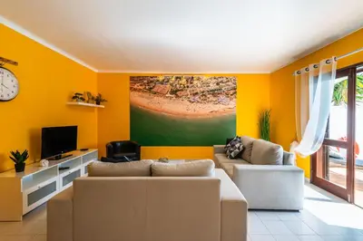 a living room with a couch and a tv at Villa Canto II - 500m from the Beach - Private Swimming Pool - Wi Fi in Guia