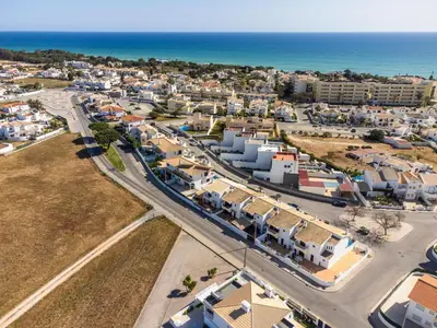an aerial view of a city with houses and the ocean at Villa Canto II - 500m from the Beach - Private Swimming Pool - Wi Fi in Guia