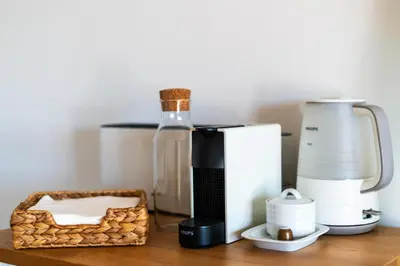 a counter with a blender and a basket on it at Albufeira Beach Apartment in Guia