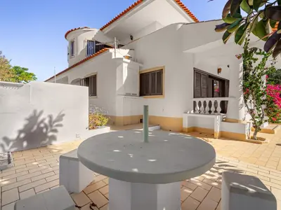 a patio with a table in front of a house at Holiday Home Vivenda Deolinda by Interhome in Albufeira