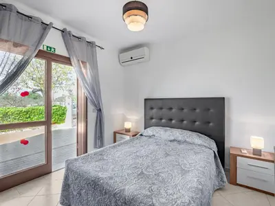 a bedroom with a bed and a window at Holiday Home Vivenda Deolinda by Interhome in Albufeira