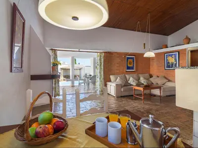 a kitchen with a table with a bowl of fruit on it at Villa Villa Genoveva by Interhome in Albufeira