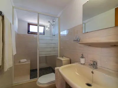 a bathroom with a sink and a toilet and a mirror at Villa Villa Genoveva by Interhome in Albufeira