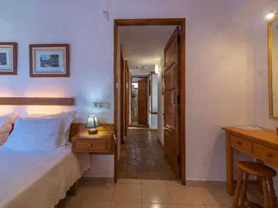 a bedroom with a bed and a desk and a hallway at Villa Villa Genoveva by Interhome in Albufeira