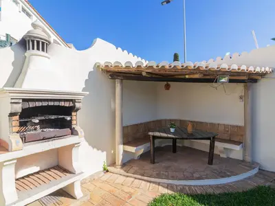 a patio with a table in the side of a house at Villa Villa Genoveva by Interhome in Albufeira