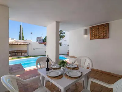 a white dining room with a white table and chairs at Villa Villa Genoveva by Interhome in Albufeira