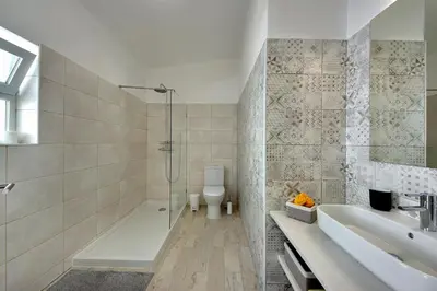 a bathroom with a shower and a sink and a toilet at Apartamentos Tucha in Albufeira