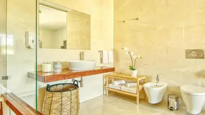 a bathroom with a sink and a toilet and a mirror at Dream Villa with Luxury Services - PROMOTION Last dates! in Vilamoura