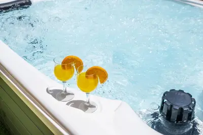 two glasses of orange juice sitting in a tub at Villa Bali by Algarve Vacation in Albufeira