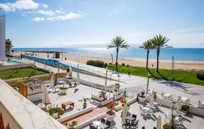 a view of the beach from the balcony of a resort at Apartamento Vista Mar T2 in Quarteira
