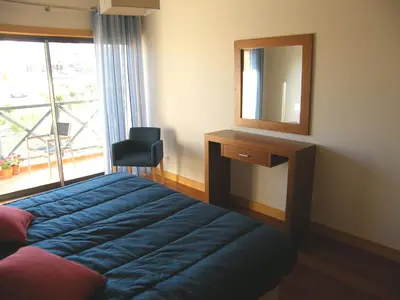 a bathroom with a toilet and a sink at Luxurious first floor apartment with balconies overlooking pool and gardens. in Albufeira