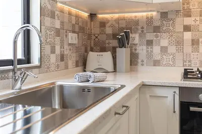 a kitchen with a sink and a counter top at Centralgarve - Great, Bright 2-bedroom Flat in the Center of Vilamoura -Topázio in Vilamoura